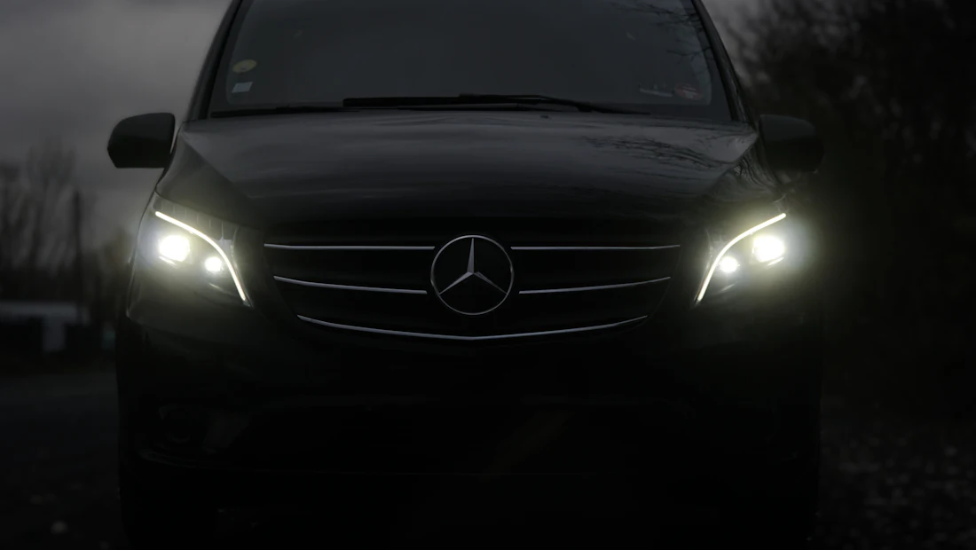 Unmarked secure transport van with headlights on at night